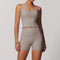 Front view of women’s beige athletic tank top and biker shorts set – Louvóre athleisure apparel