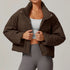 Front view of women’s brown down filled puffer jacket on model – Louvóre athleisure apparel