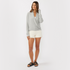 Front view of women’s heather gray waffle knit long sleeve tie front cardigan on model – Louvóre athleisure apparel